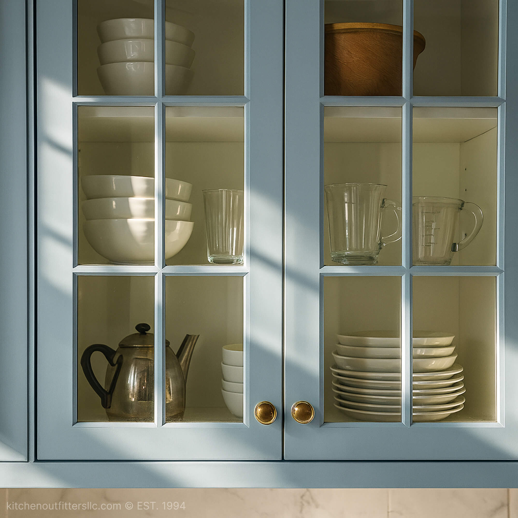 6-light grid mullion glass cabinet doors in blue kitchen cabinet with classic divided glass panel design
