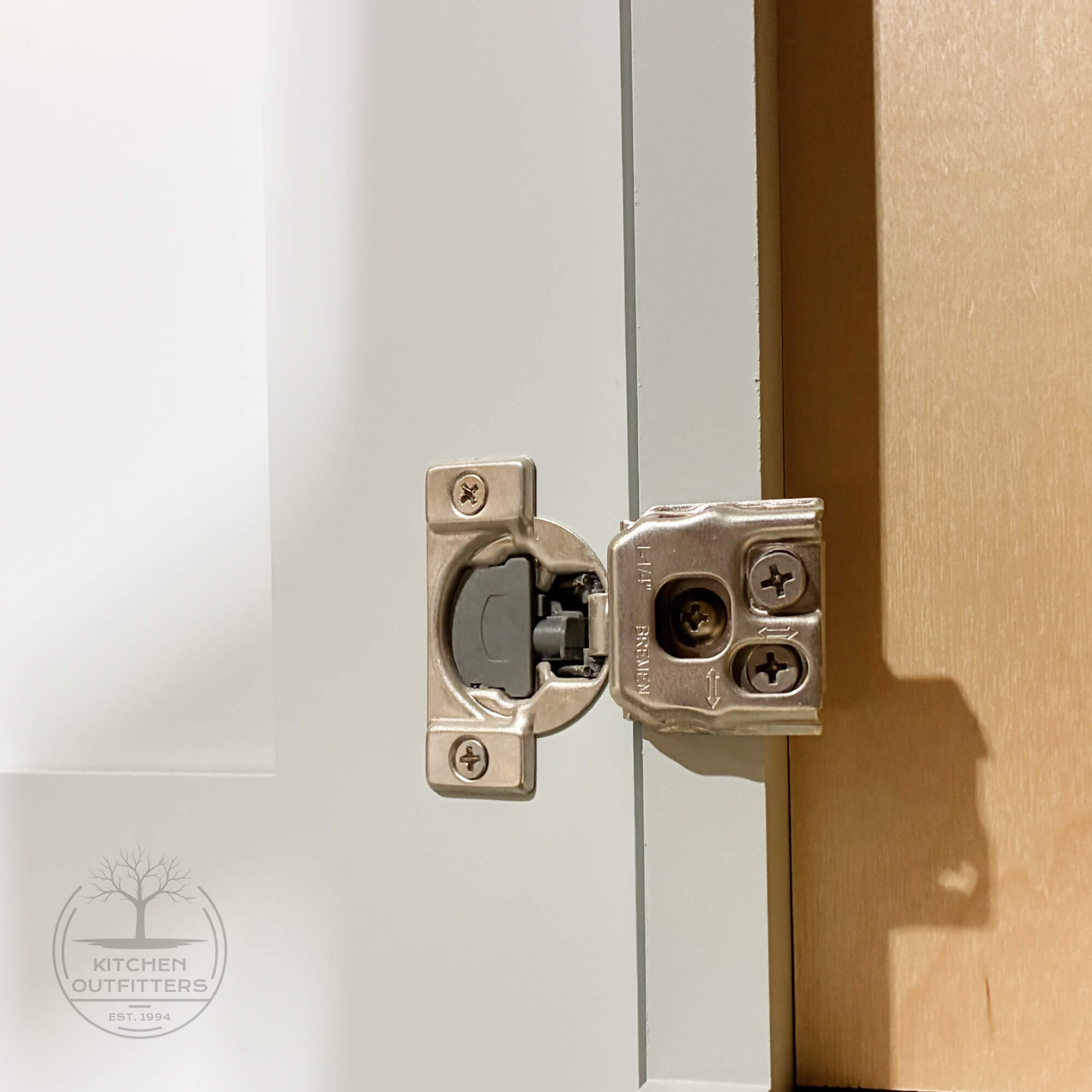 Soft-close concealed cabinet hinge installed on full-overlay Shaker cabinet door