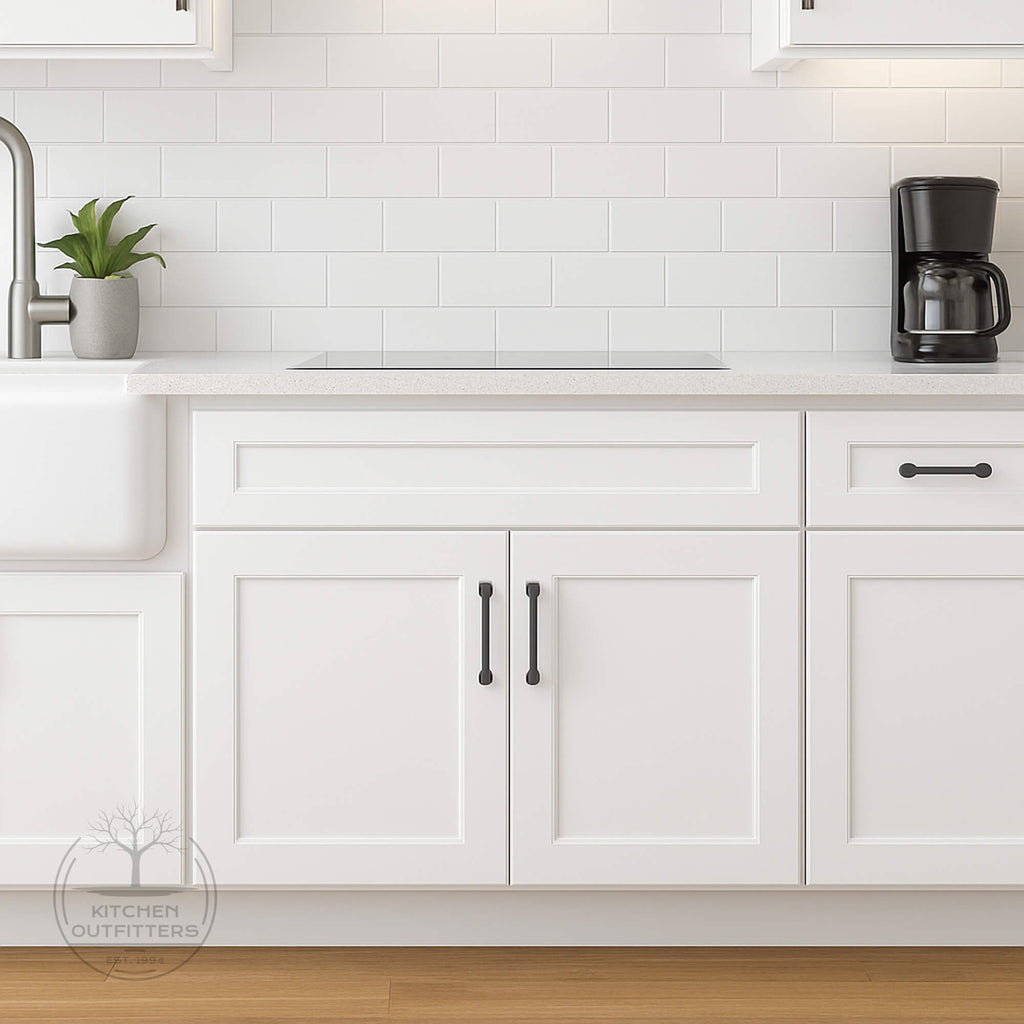 White Shaker sink base cabinet with full-overlay doors and black hardware