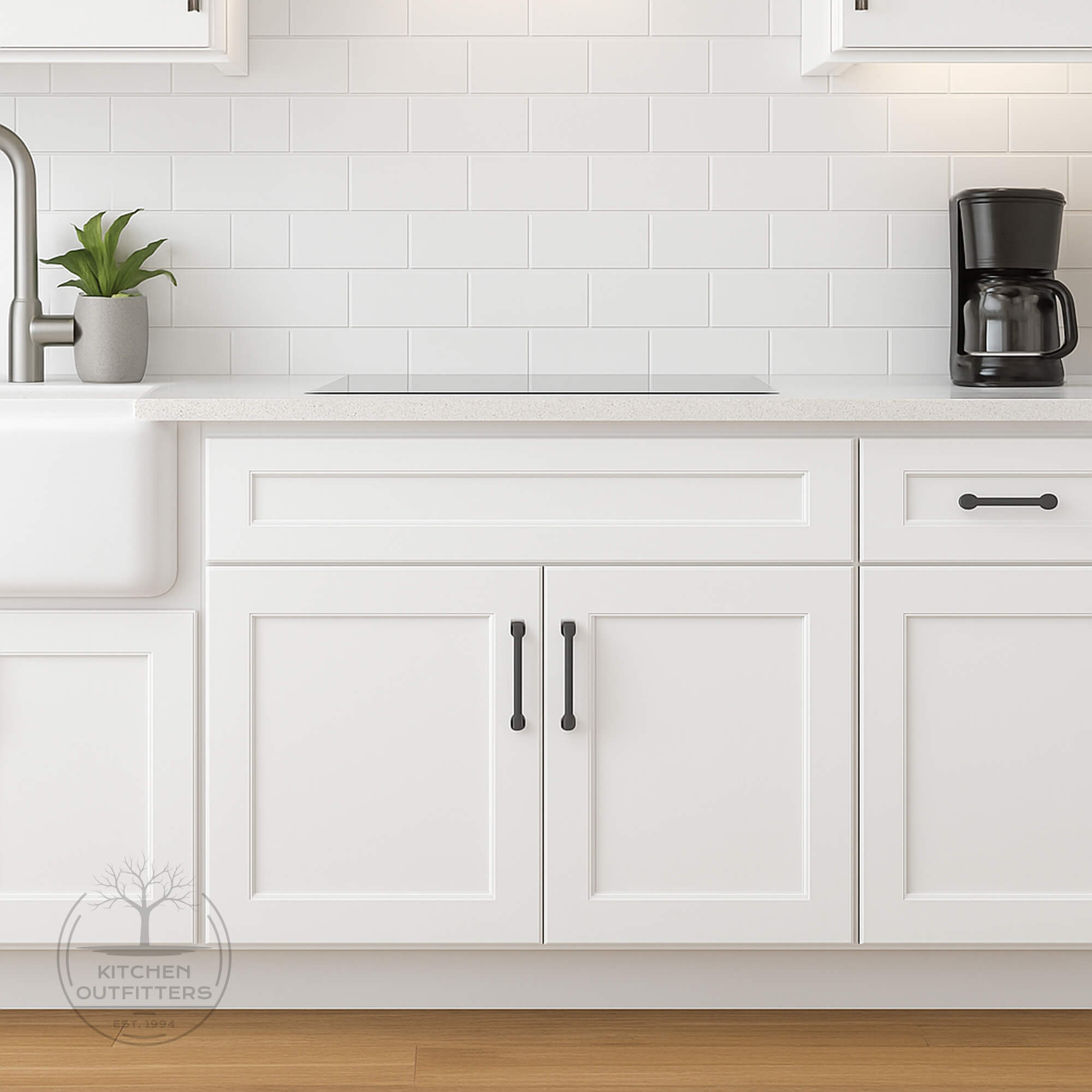 White Shaker sink base cabinet with full-overlay doors and black hardware